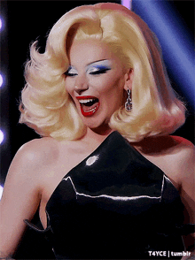 a woman with blonde hair and red lips is wearing a black top