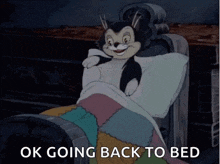 a cartoon cat is laying in bed with the words ok going back to bed