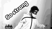 a black and white photo of a person wearing a mask with the words so strong written on it