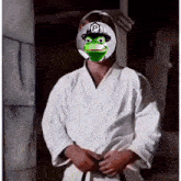 a man in a karate uniform has a frog on his face