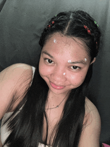 a woman with a braided headband and a necklace on her neck