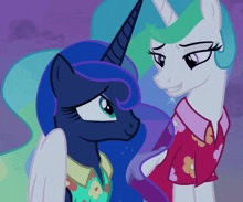 two ponies are standing next to each other and one is wearing a red shirt with flowers on it