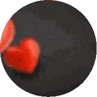 a black circle with red hearts in the center