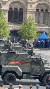 a row of military vehicles are lined up on a street