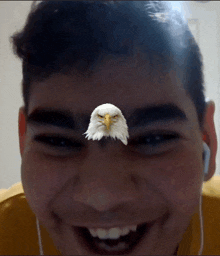 a man with a bald eagle on his forehead is smiling