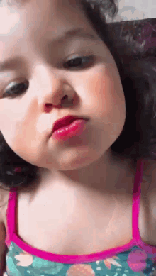 a little girl is making a face with her mouth open
