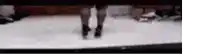 a blurry picture of a person 's feet walking on a snowy surface .