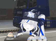 a girl wearing a hat that says npo is sitting in front of a renault truck