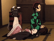 a girl laying on the floor next to a man in a checkered shirt