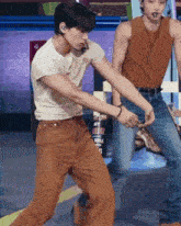 two men dancing in front of a sign that says my garage