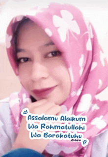 a woman wearing a pink scarf with the words assalamu alaikum wa rahmatullahi wa barakatuhu