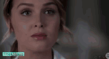 a close up of a woman 's face with the words grey 's anatomy behind her