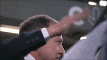 a man in a suit is pointing at a sign that says cnv