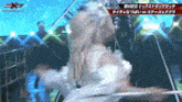 a woman in a white dress is dancing in front of a sign that says x-men