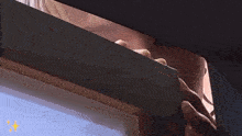 a close up of a person covering their face with a shadow