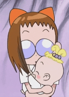 a woman is holding a baby in her arms