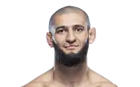 a man with a shaved head and a beard is looking at the camera