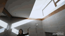 a woman in a bathroom with the words made in animotica on the bottom right