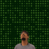 a man stands in front of a green background with the number 21