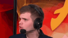 a man wearing headphones and a microphone is talking into it