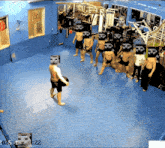 a group of men standing in a gym with their heads covered with skulls