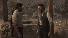 two men standing next to each other with one holding a rifle