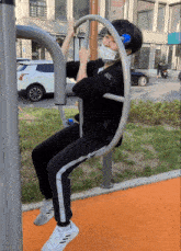a person wearing a face mask is sitting on a machine with a sign that says ' a ' on it