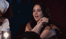 a woman with a snake tattoo on her arm
