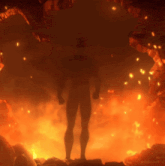 a silhouette of a man standing in a cave with flames coming out of it
