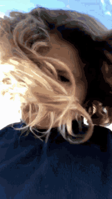 a woman 's hair is blowing in the wind