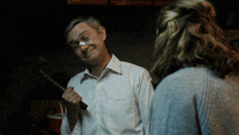 a man with a bandage on his nose is holding a large knife