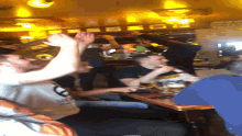 a group of people are sitting at a table and one of them is wearing a shirt that says ' oakland ' on it