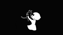 a black and white drawing of a girl holding a cat with a red heart in the background