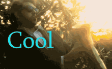 a man in a suit is playing a saxophone and the word cool is on the bottom right