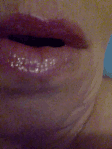 a close up of a person 's mouth with a blue background