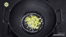 a pan of food is being cooked on a stove and the words made in animotica are on the bottom of the pan