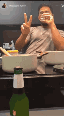 a man is giving a peace sign in front of a pot