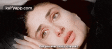 a woman is laying on a bed with her hand on her face and a question asked .