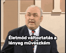 a man in a suit and tie says " eletmod vallozatas a lenyeg művészetem "