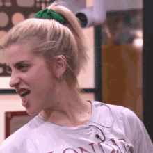 a woman with a ponytail and a t-shirt that says ' one ' on it