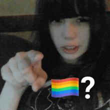 a girl with a rainbow flag and a question mark in front of her
