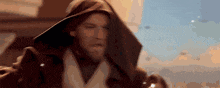 a close up of a man wearing a hooded cloak in a star wars movie .