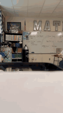 a classroom with a whiteboard that says math on it