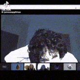 a man with curly hair is having a video call with a group of people .