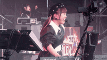 a woman playing a roland keyboard in front of a sign that says silent
