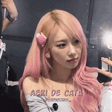 a girl with pink hair has the name aeri de cata on the bottom