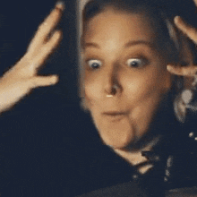 a woman with a surprised look on her face and the words whaa- on her face