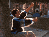 a man sits on a bench with his hand on his face