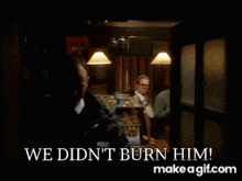 a man sitting at a table in a dark room with the words we did n't burn him