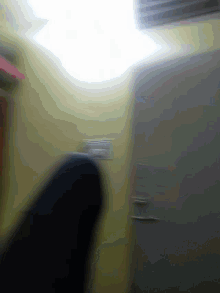 a blurry picture of a wall with a light shining through